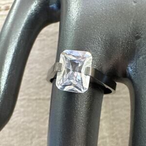 Size 7.5 Silver Tone Ring Possibly Stainless Steel Emerald Cut Clear Stone